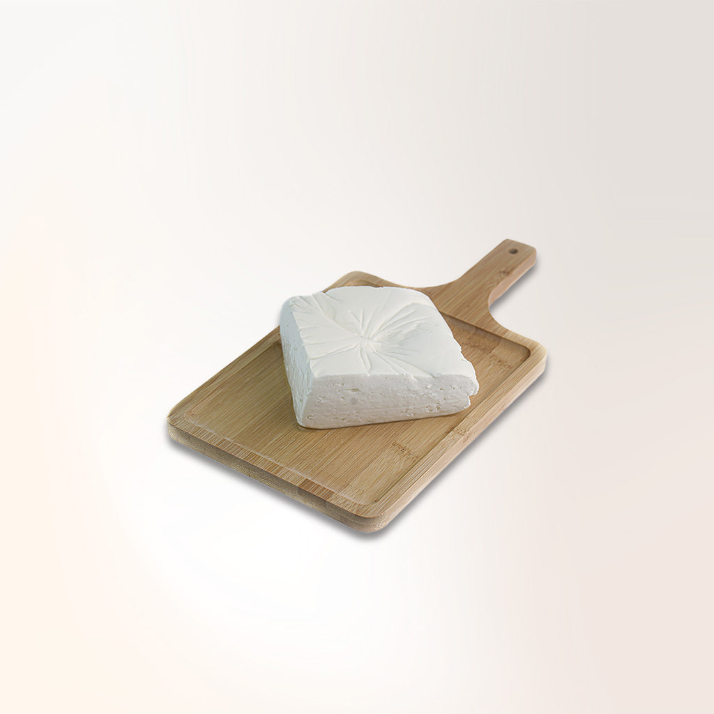 fresh paneer cheese on a wooden platter