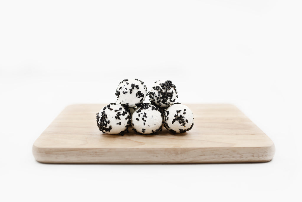 Labneh Ball with Blackseeds on a wooden platter